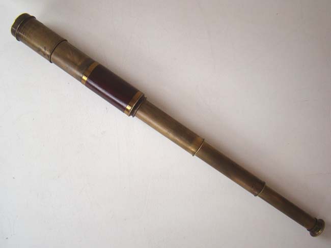 An Antique English three-draw telescope with mahogany barrel and pull out sun shade circa 1840-1850